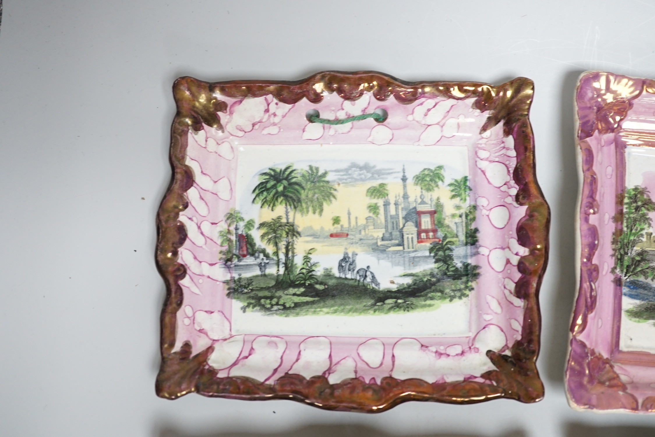 A set of four Dixon and Co. Sunderland pink lustre rectangular plaques, with copper lustre borders printed and hand coloured, impressed marks, 22cm wide